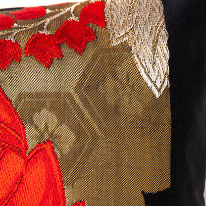Gold accent cushion with red and black details.