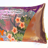 End of a long silk pillow with metallic gold woven silk and embroidered flowers