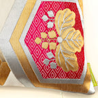 Close-up of the red hexagon Kiri flower pattern detailing intricate embroidery on the Obi pillow surface.