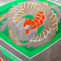 Detail of gold Phoenix on green vintage obi silk by Hunted and Stuffed