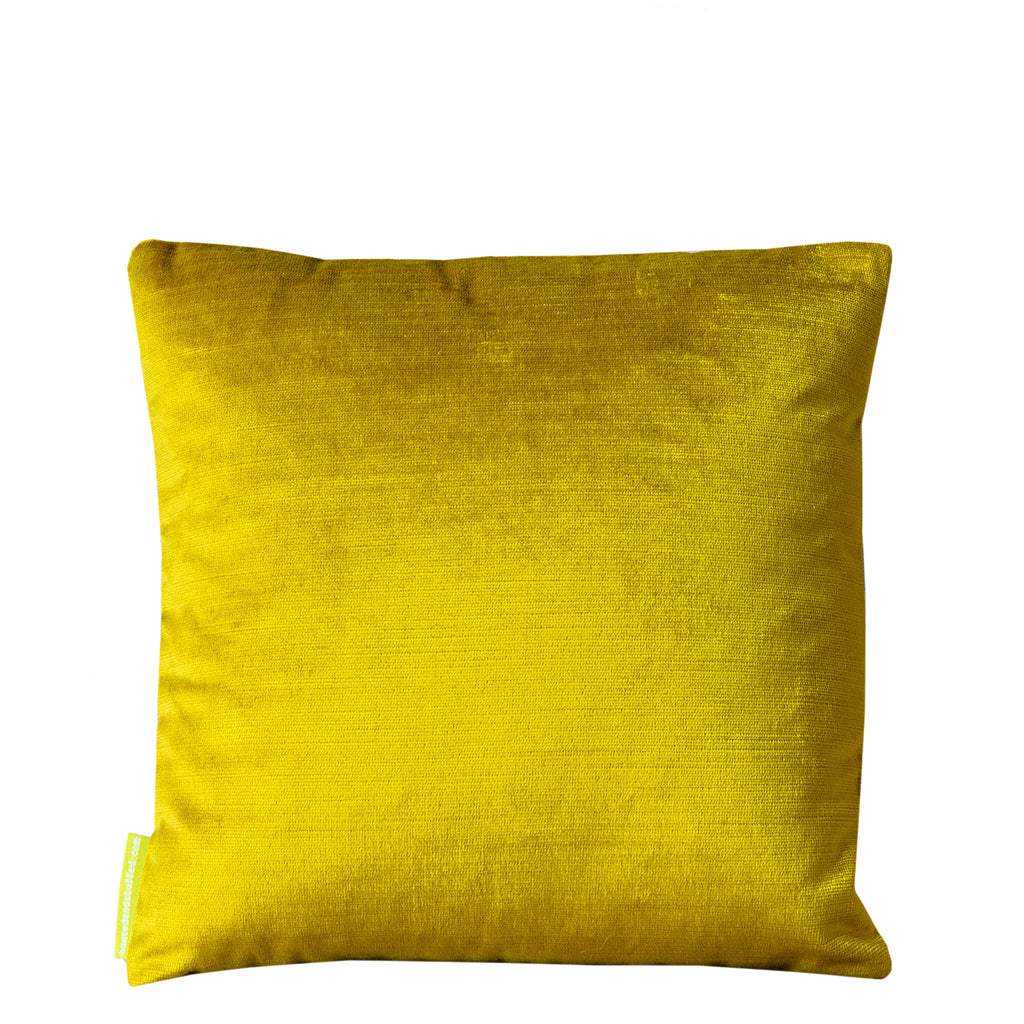 Close-up of gold geometric embroidery detail on the chartreuse velvet Obi pillow’s corner, highlighting textured stitching