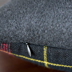 Close-up of the tartan grey wool fabric showing textured weave and intricate pattern detail on the Gannnex vintage cushion