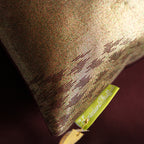 Close-up of the textured bronze silk fabric highlighting intricate kimono-inspired weaving and subtle metallic sheen in