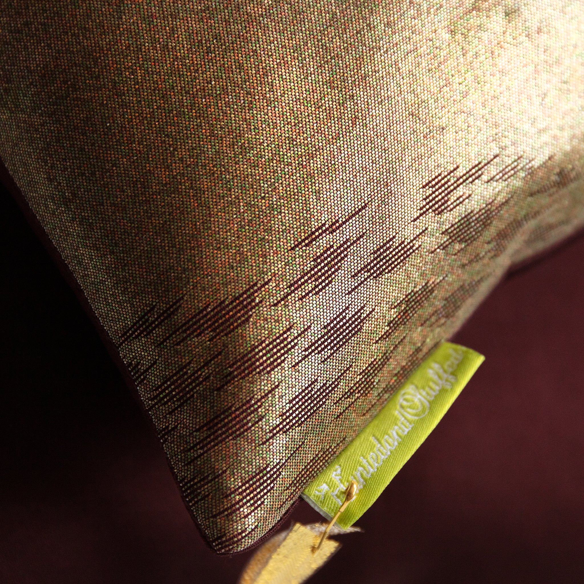 Close-up of the textured bronze silk fabric highlighting intricate kimono-inspired weaving and subtle metallic sheen in