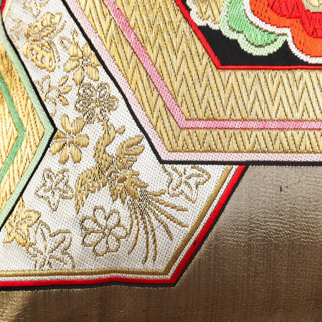 Close-up of gold hexagon accents embroidered onto vintage obi silk with intricate stitching details and subtle sheen.