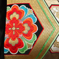 Japanese obi pillow with red flower accent and gold embroidery