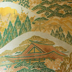 Close-up of the Nishijin kimono silk fabric showcasing intricate mountain temple embroidery and vibrant colors on the
