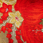 Close-up of the vibrant red and gold embroidered details on the vintage obi cushion fabric, highlighting intricate stitching
