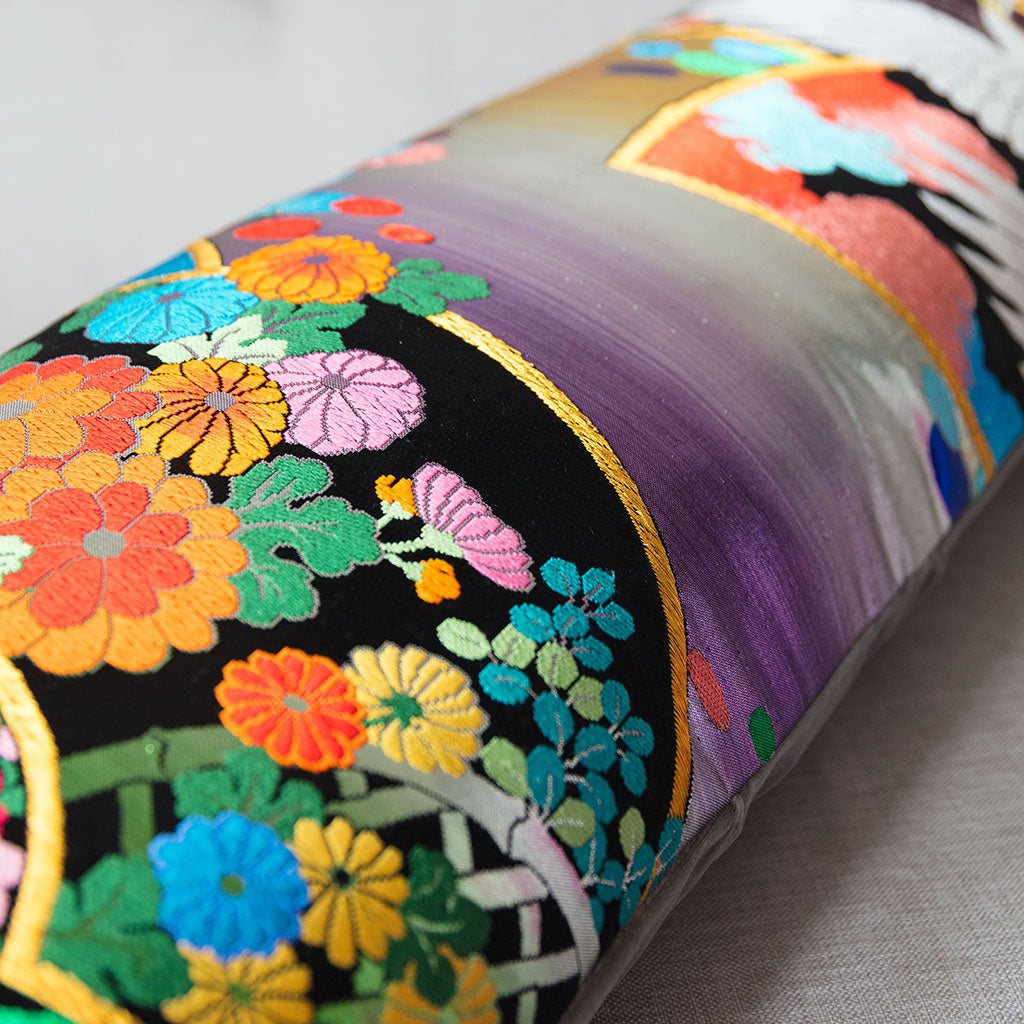 Close-up of the grey velvet fabric highlighting the intricate rainbow silk embroidery detail on the vintage wedding kimono