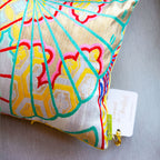Close-up of the vibrant yellow bolster cushion fabric showing detailed oriental fan embroidery on silver kimono silk, from a