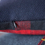 Close-up of the navy tartan fabric highlighting intricate woven pattern and rich texture of the vintage Gannex cushion edge