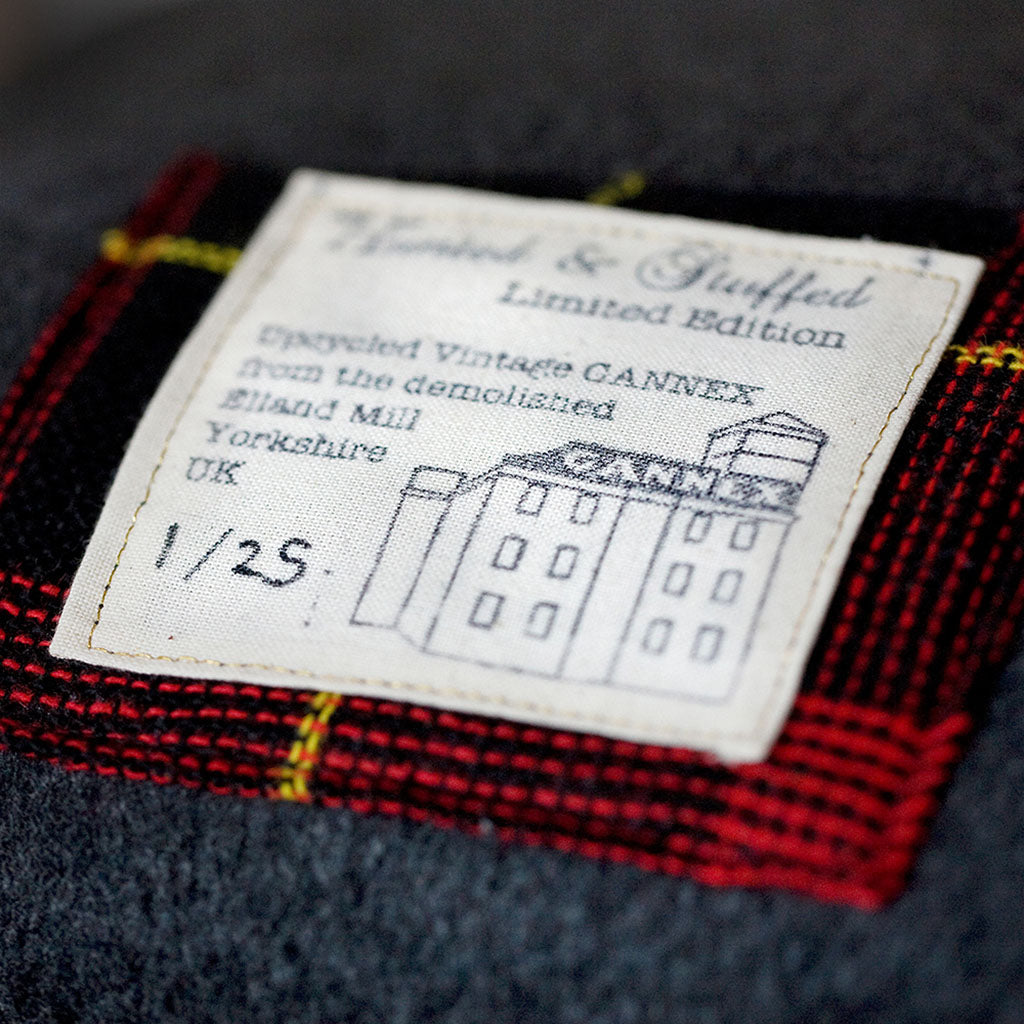 Close-up of grey tartan wool texture highlighting intricate weave and soft fibers of the Gannnex Vintage Cushion Cover.