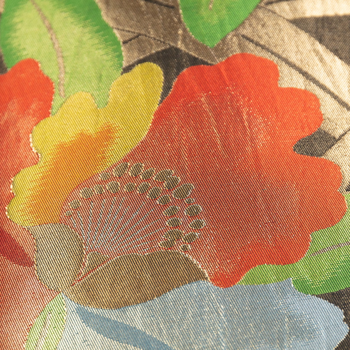 Detail of obi pillow with rd flowers and gold accents