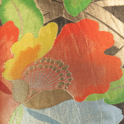 Detail of obi pillow with rd flowers and gold accents