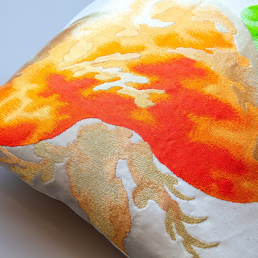 Close-up of the textured orange and green matsu pine fabric on the pillow's corner, highlighting intricate weaving details.