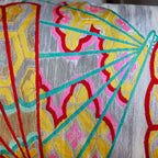 Close-up of vibrant yellow velvet bolster detailing the vintage kimono silk fan prints with visible stitching and rich
