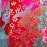 Detail of metallic crane and floral embroidery on oriental pillow