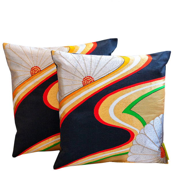 Pair of obi cushions in black and gold silk with floral and river design made with vintage obi silk