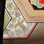 Close-up of the gold hexagon embroidery revealing textured silk threads and precise stitching on the vintage black silk