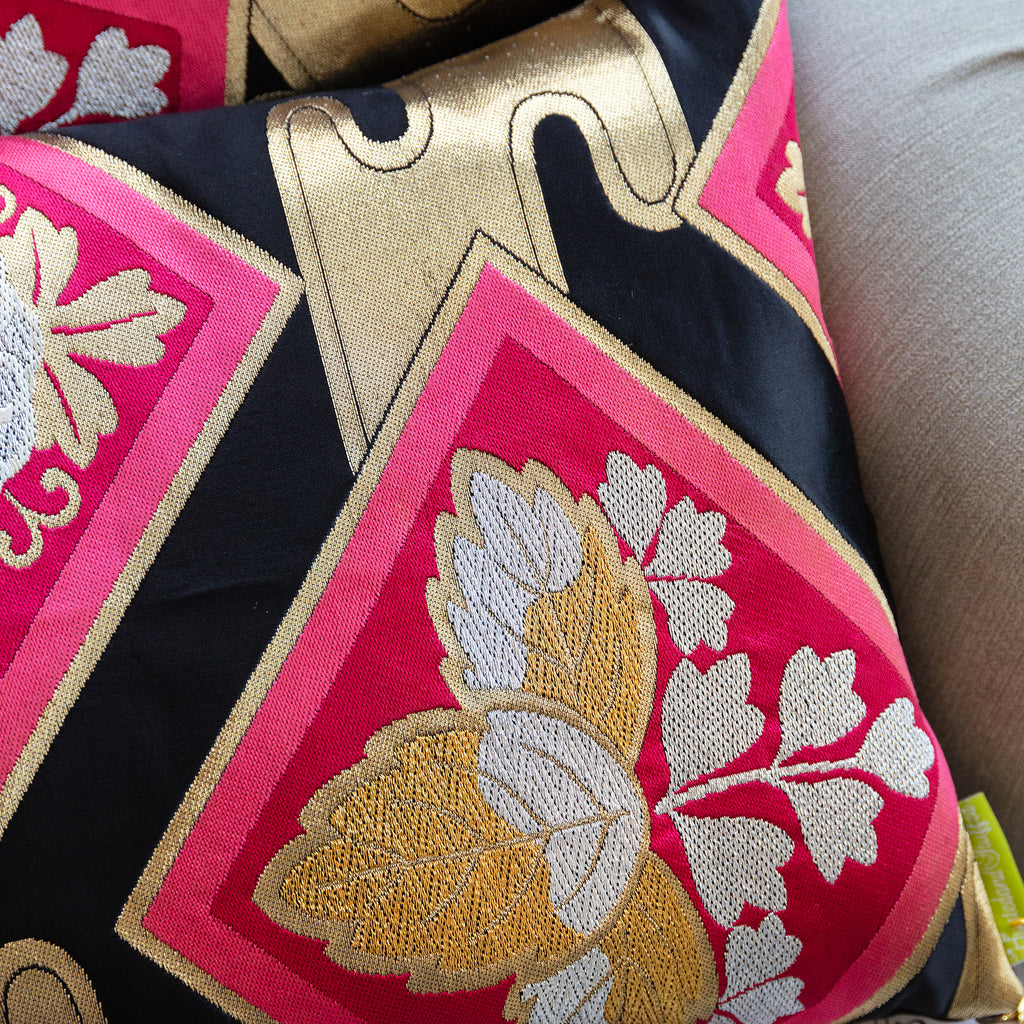 Close-up of gold embroidered accents on the black silk fabric of the Pink Obi Pillow Set, showcasing intricate detail and