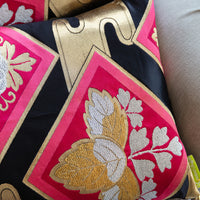 Black and pink obi pillow with gold accents
