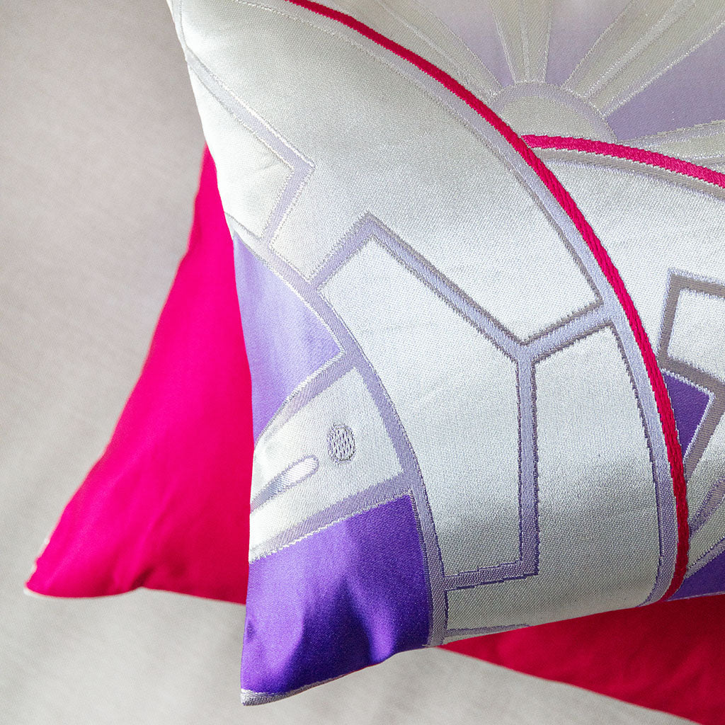 Close-up of the pink silk backing showcasing smooth texture and subtle sheen behind the Silver Purple Obi Cushion with Genji