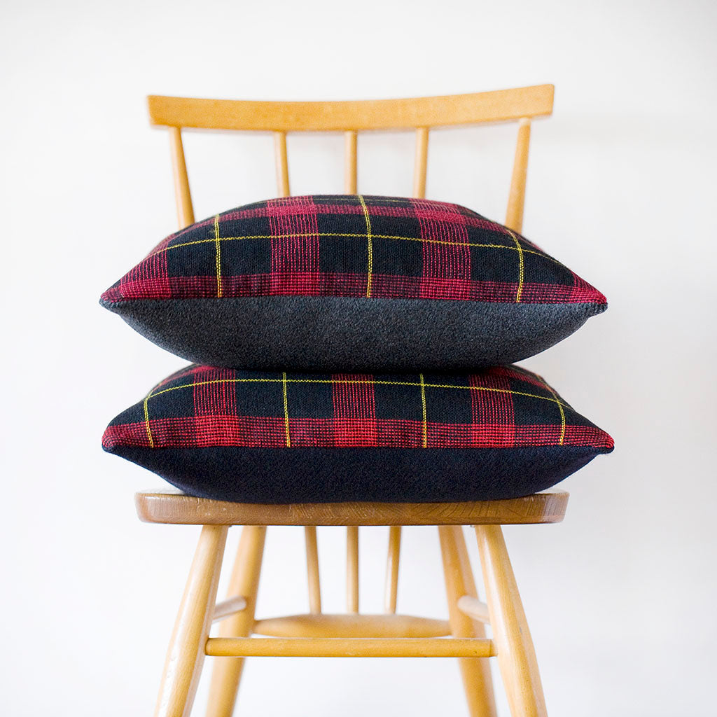 Close-up of navy wool tartan pattern highlighting intricate weaving and rich texture on the Harold Ltd Edition cushion cover.