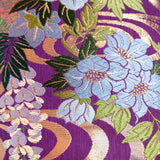 Deatil of purple floral silk pillow with floral silk embroidery in green and blue silk threads