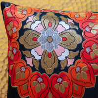 Detail of floral motif on a red and black obi cushion by Hunted and Stuffed