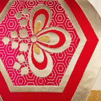 Obi pillow with red kiri and golden hexagons pattern. Detail .