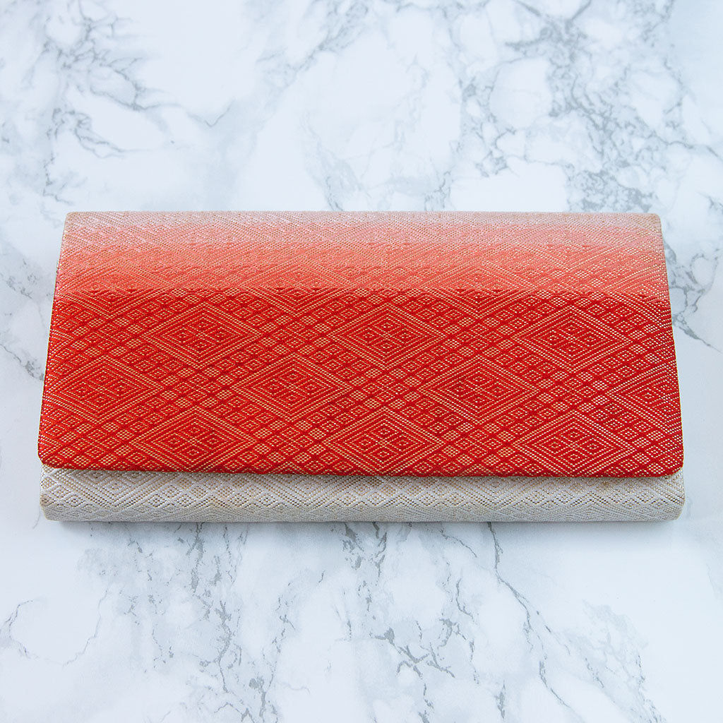 Close-up of the clutch’s ombre fabric texture and intricate fold details, highlighting the vintage kimono-inspired