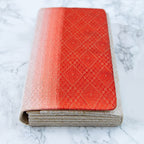 Close-up of the red ombre fabric's textured pleats and folded edge detail, highlighting vintage kimono craftsmanship and