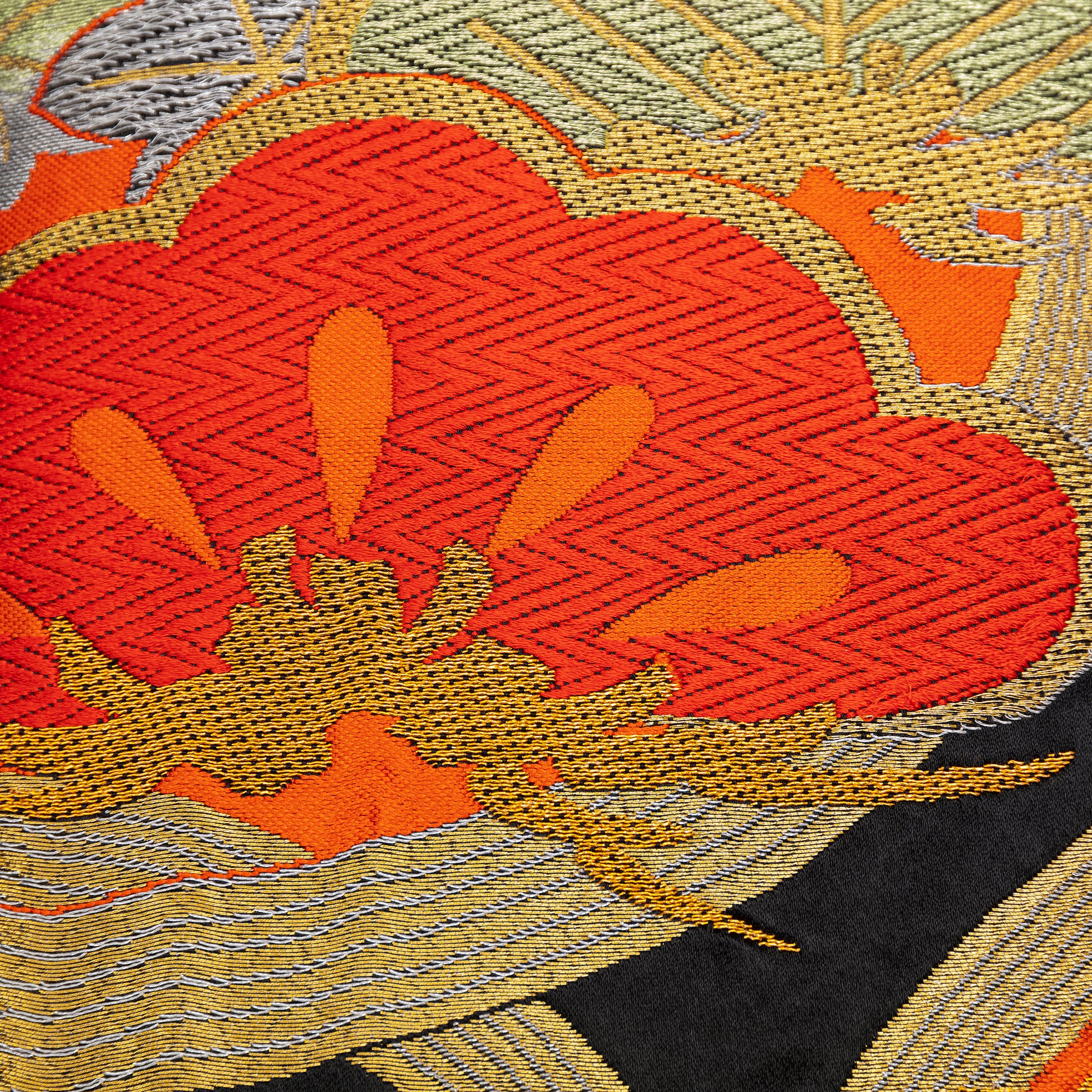 Detail of stylised pine (matsu) in red silk thread with metallic gold accents over black silk. Upcycled vintage obi.