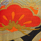 Detail of stylised pine (matsu) in red silk thread with metallic gold accents over black silk. Upcycled vintage obi.