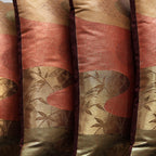 Close-up of intricate bronze obi silk weave showcasing subtle river-inspired patterns and rich textured surface detail.