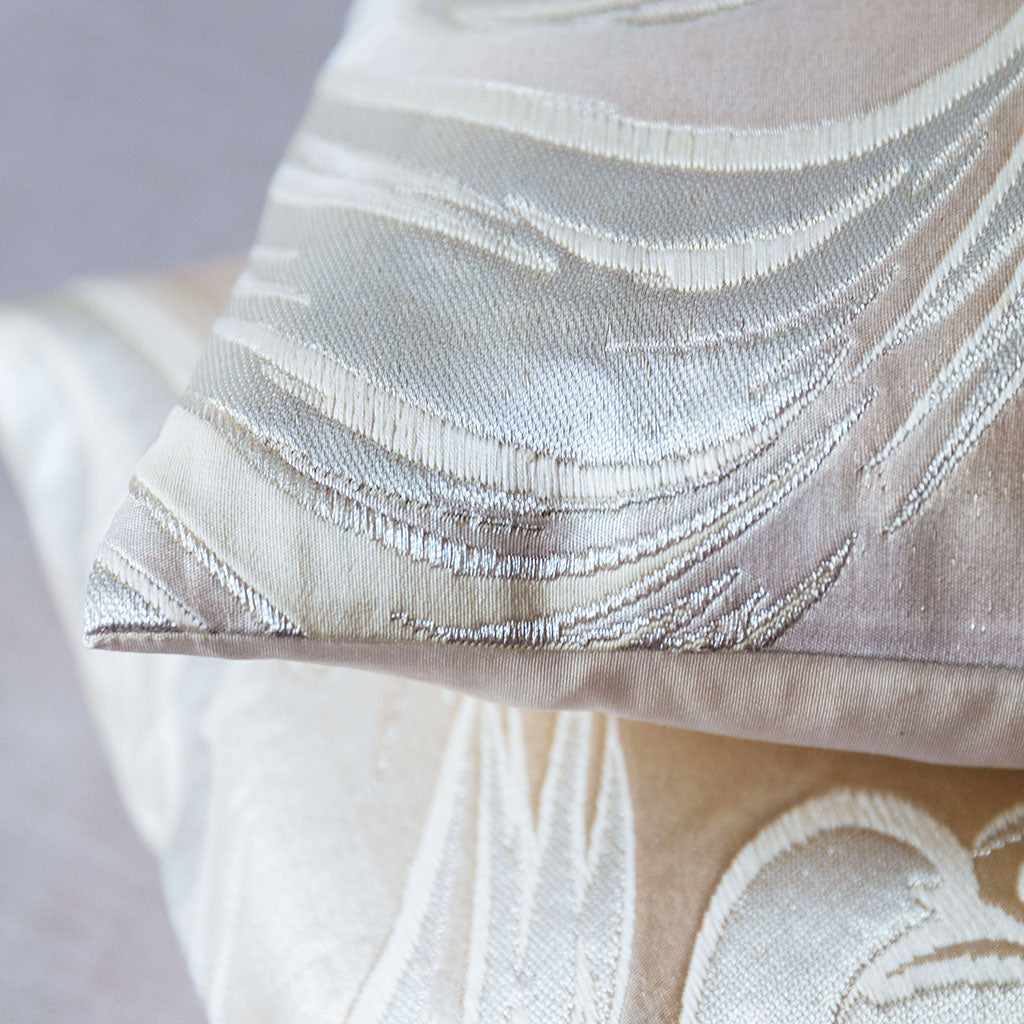 Close-up of the intricate silver silk embroidery detail on the vintage obi pillow, highlighting its textured and shimmering