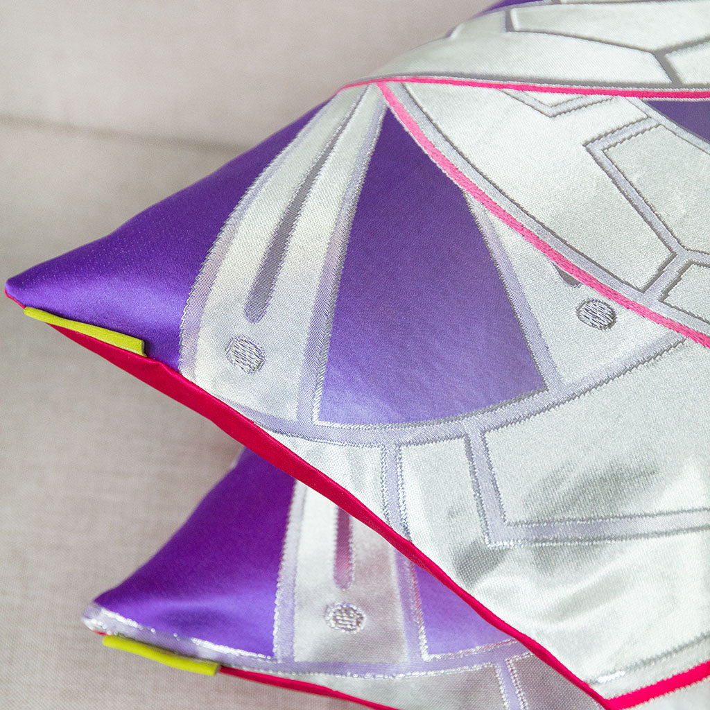 Close-up of the Silver Purple Obi Cushion's pink silk backing showing textured embroidery and intricate stitching detail.