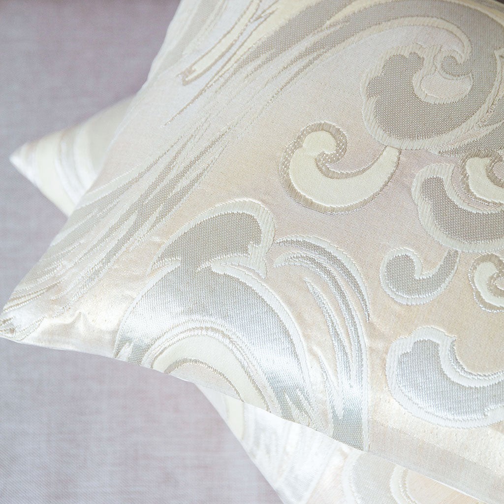 Close-up of the intricate silver silk obi pattern highlighting delicate woven details and subtle sheen on the cushion