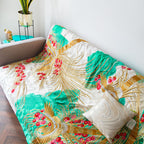 Close-up of intricate gold phoenix embroidery on silk throw blanket border highlighting vintage floral motifs and rich