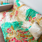 Close-up of the gold phoenix embroidery detail on the silk throw blanket’s vintage kimono-inspired design, highlighting