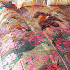 Close-up of vintage kimono-inspired silk throw blanket’s intricate floral embroidery and rich jewel-tone colors from a