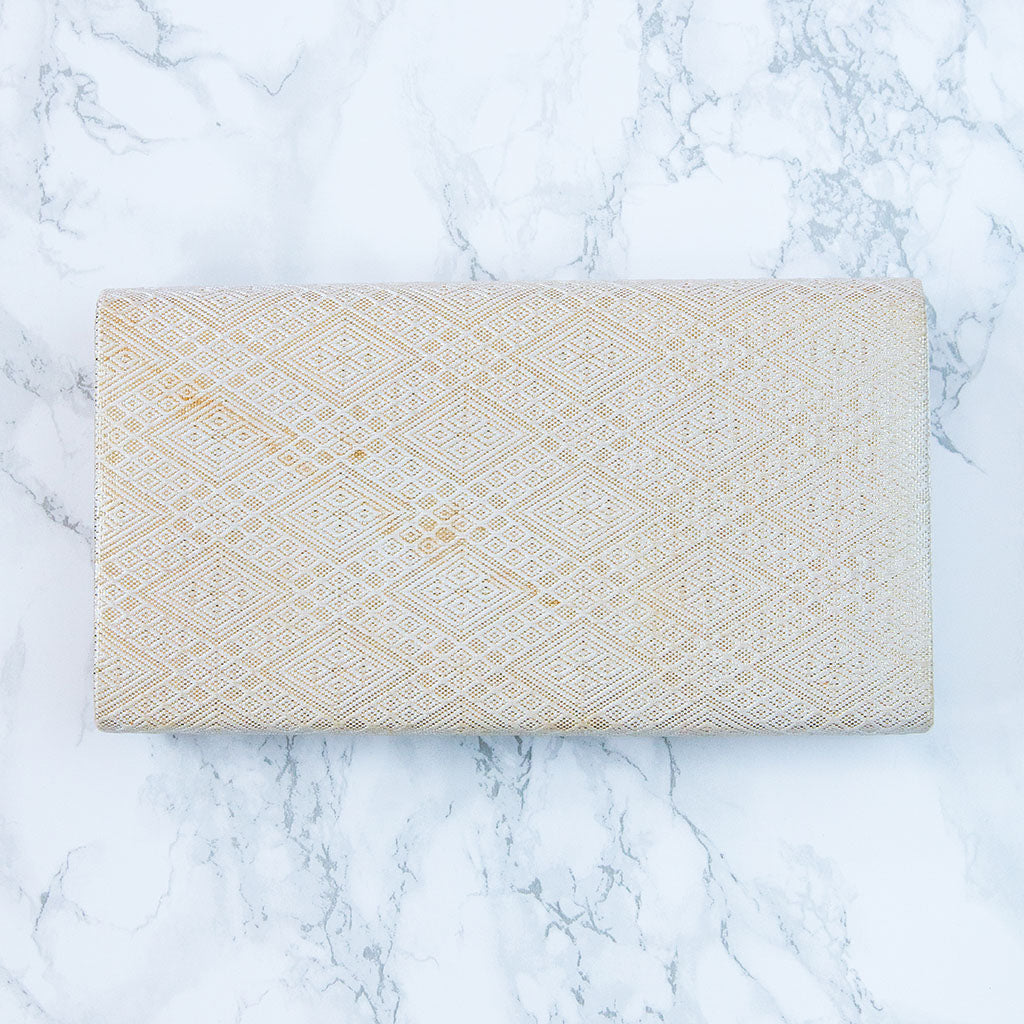 Close-up of the ombre fabric folds highlighting the rich red hues and subtle texture details of the vintage kimono clutch.