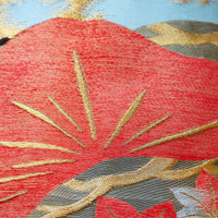 Detail of the vintage japanese obi pillow with matsu pines in orange and gold embroidery.