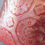 Close-up of the pink silk fabric highlighting silver geometric embroidery detail on the 1930s Obi cushion’s 12-inch textile
