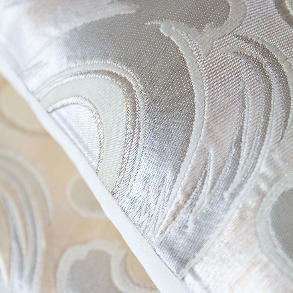 Close-up of intricate silver silk embroidery detail on the white Japanese Wave Cushion fabric edge.