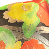 Detail of yellow floral pillow with gold leaves